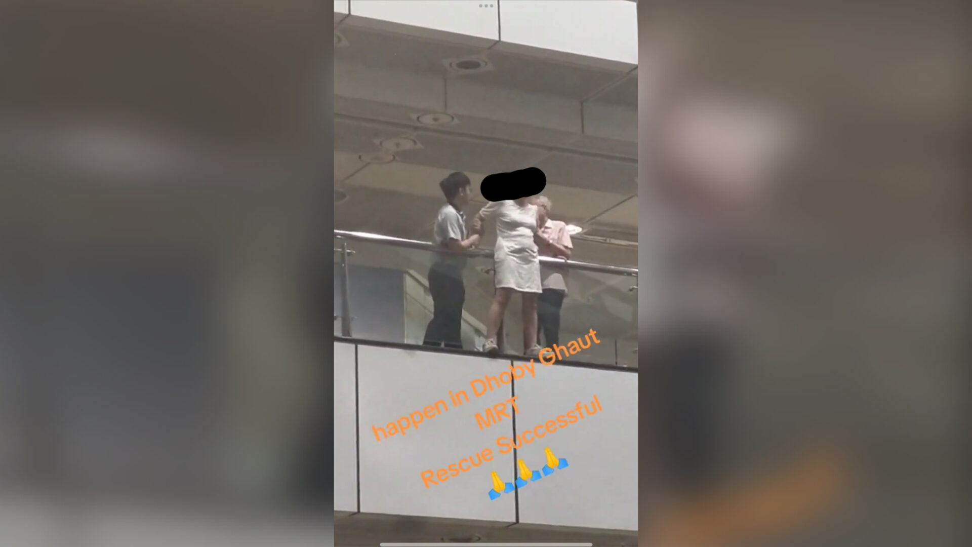 woman-standing-on-edge-of-railing-at-dhoby-ghaut-mrt-station-rescued-by-2-individuals